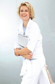 A blonde woman wearing a white shirt-blouse an holding books