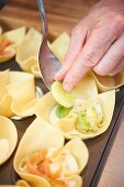 Pasta muffins with leek, smoked salmon and lime cream being made
