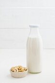Cashew nut milk in a glass bottle