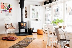 Log burner and glass wall in spacious dining room