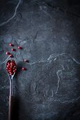 Red peppercorns on a spoon