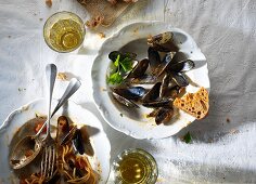 The remains of spaghetti and mussels on a plate