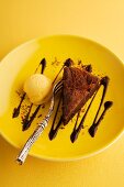 A slice of chocolate mousse cake with pumpkin ice cream