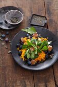 Vegan salad with lamb's lettuce, pumpkin, blueberries, pumpkin seeds and croutons