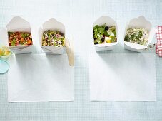 Four filling low carb salads in takeaway boxes