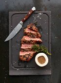 A grilled ribeye steak with sauce