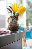 Kitchen utensils in a jug painted with a lion