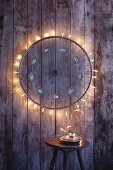 An old bicycle wheel upcycled with fairy lights to make a Christmas decoration