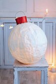 A giant Christmas bauble made from a balloon and silk paper