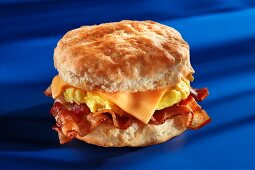 Bacon, scrambled eggs and cheese on an American biscuit