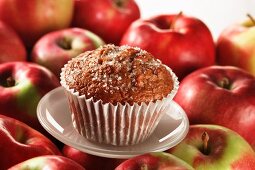 An apple muffin on red apples