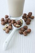 Hazelnut milk and hazelnuts on a spoon