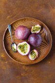 Passion fruits on a wooden dish