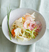 Apple carpaccio with fresh vegetables and buckwheat
