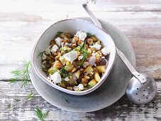 Vegetarian fried potatoes with nuts and sheep's cheese