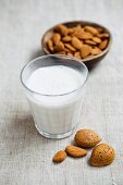 A glass of almond milk and a bowl of almonds
