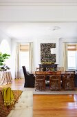 Dining table with wicker chairs in the spacious living room