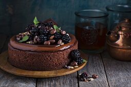 Chocolate cheesecake with blackberries on rustic wooden surface