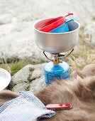 Camping utensils on rocky ground