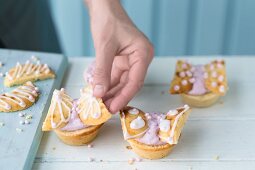 Butterfly cupcakes being decorated