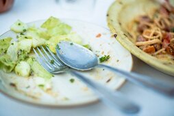 The remains of salad on a plate