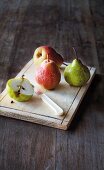 Assorted pears on a wooden chopping board
