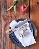 Old cutlery and linen napkin on plate