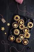 Freshly baked mince pies in an old baking tin