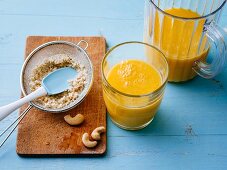 Gluten-free mango drink with cashew nuts