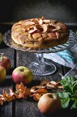 Apple cake with dried apple rings on a cake stand