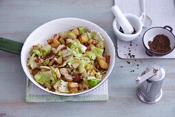 Quick fried potatoes with white cabbage and bacon