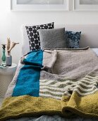 Homemade knitted colour block blanket made from a mixed wool yarn