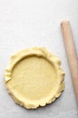 A tart being made: pastry being placed in a tart tin