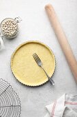 Making a tart: shortcrust pastry base being stabbed with a fork for blind baking