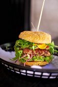 A burger with aubergine and rocket