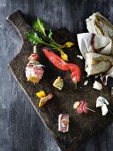 A rustic tapas platter with a red chilli pepper