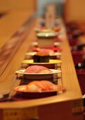 Sushi on a conveyor belt in a restaurant