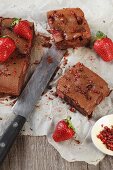 Chocolate tray bake cake with a strawberry cream filling and pink pepper