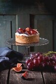 A homemade tart with red grapes, figs and whipped cream