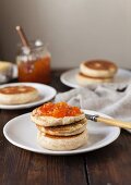 A toasted English muffin spread with jam