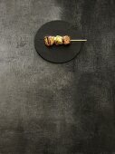 Grilled meat kushi on a bamboo skewer