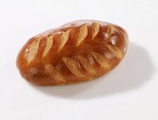 A whole loaf of bread decorated with a wheat pattern