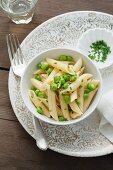 Penne pasta with broad beans and peas