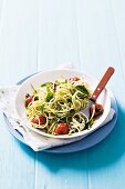 Noodles with tomatoes, pesto and basil