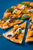 A sweet pizza with persimmons and nuts