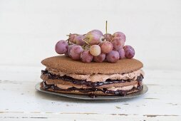 Chocolate cake with great charm, chocolate cream and red grapes