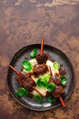 Venison skewers with cinnamon on a bed of celery cream