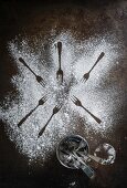 An arrangement of icing sugar and forks