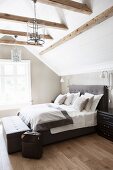 Attic bedroom with exposed beams and panelled walls