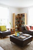 Dark brown leather furniture, rug and wooden corner shelves between pale lattice windows in comfortable living room